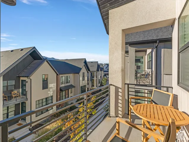 Private balcony with a metal railing and stucco exterior