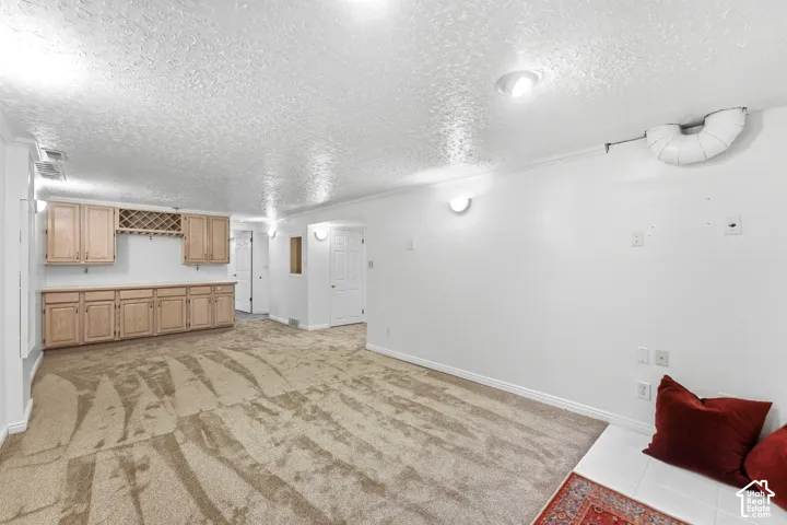 Built-in cabinetry with wood-finish doors and a wine rack