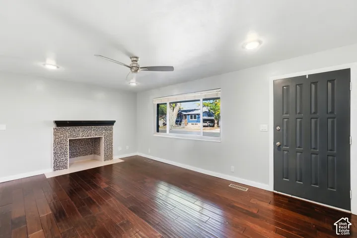 Dark wood-finish flooring, recessed lighting, and a modern ceiling fan