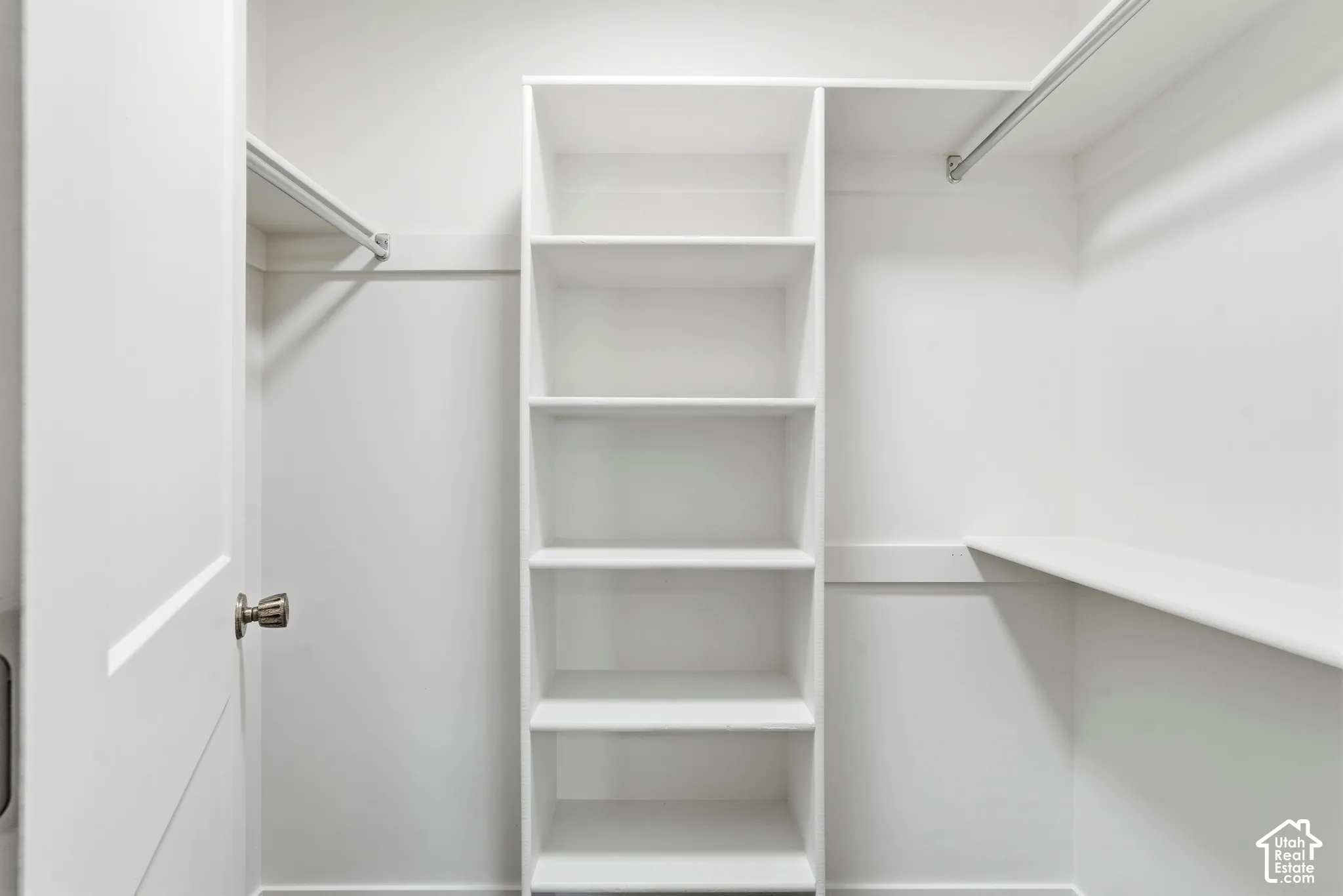 Primary Built-in shelving unit, multiple hanging rods, and an integrated shelf provide storage