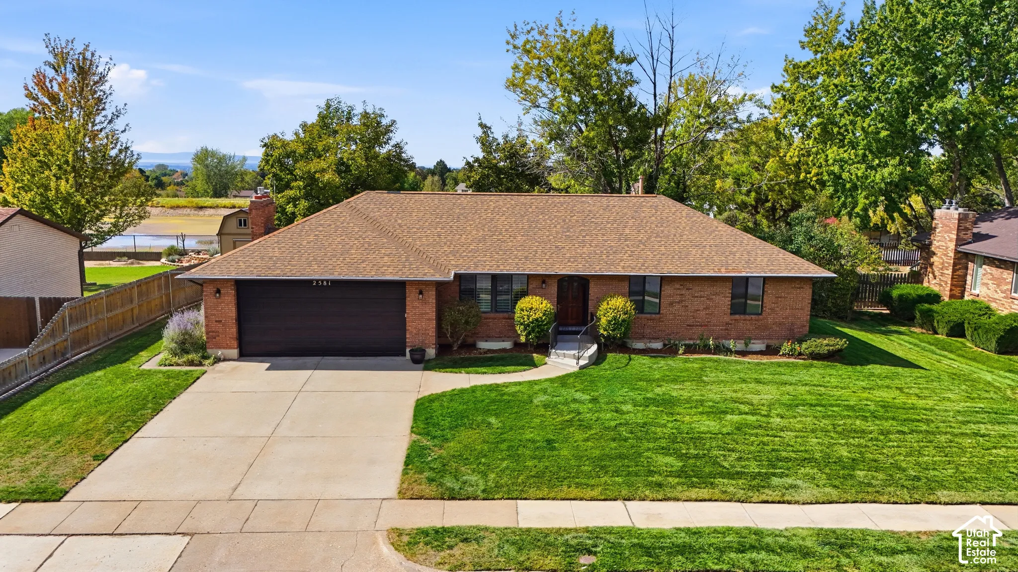 Brick exterior with a shingle roof and an attached garage