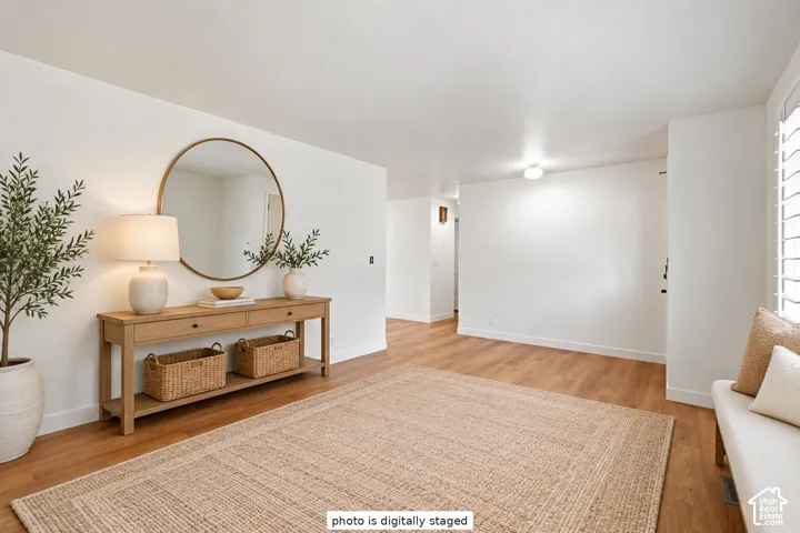 Interior space featuring wood-finish flooring, smooth-finish walls, and plantation shutters