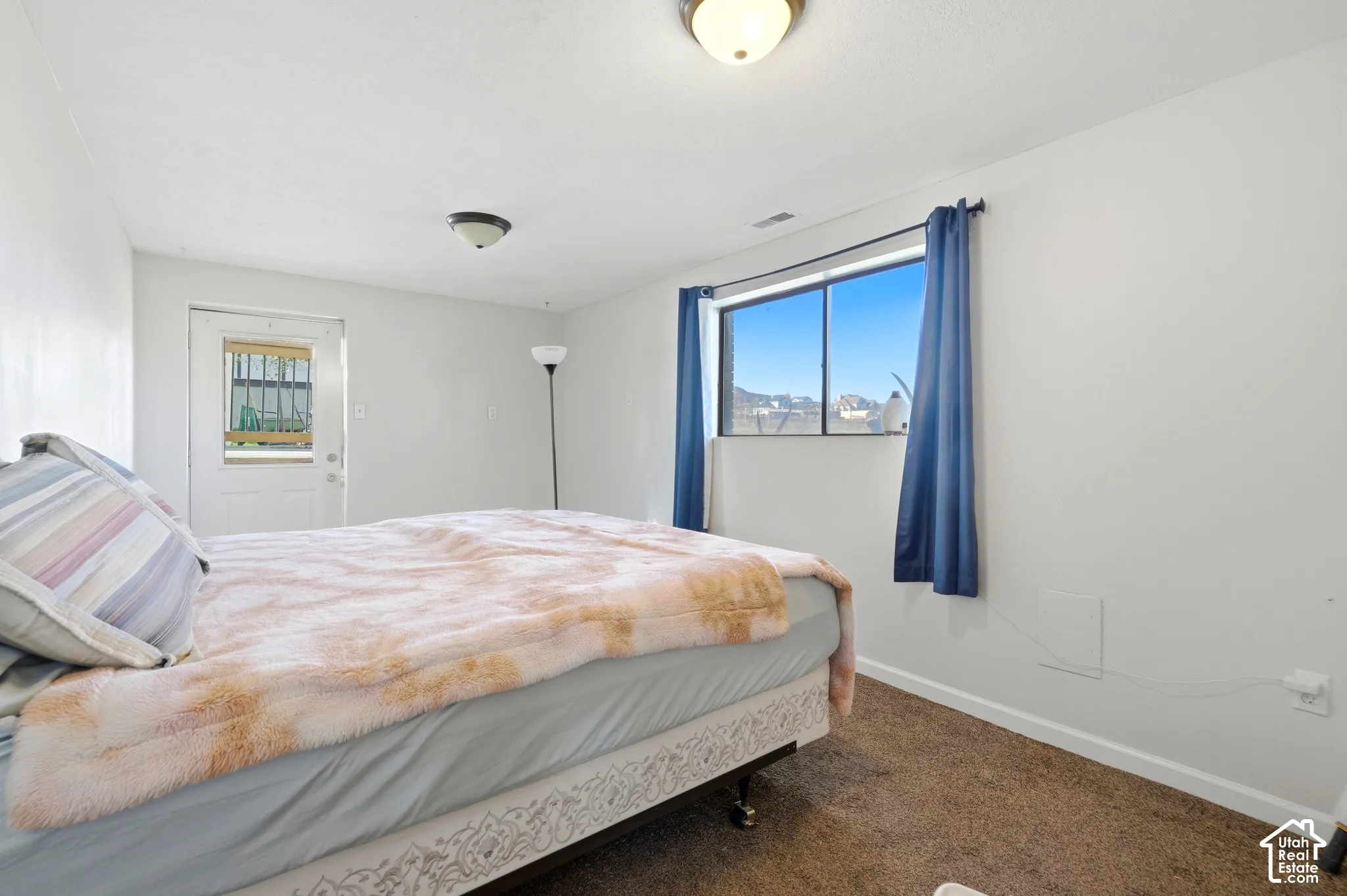White walls with brown carpet flooring