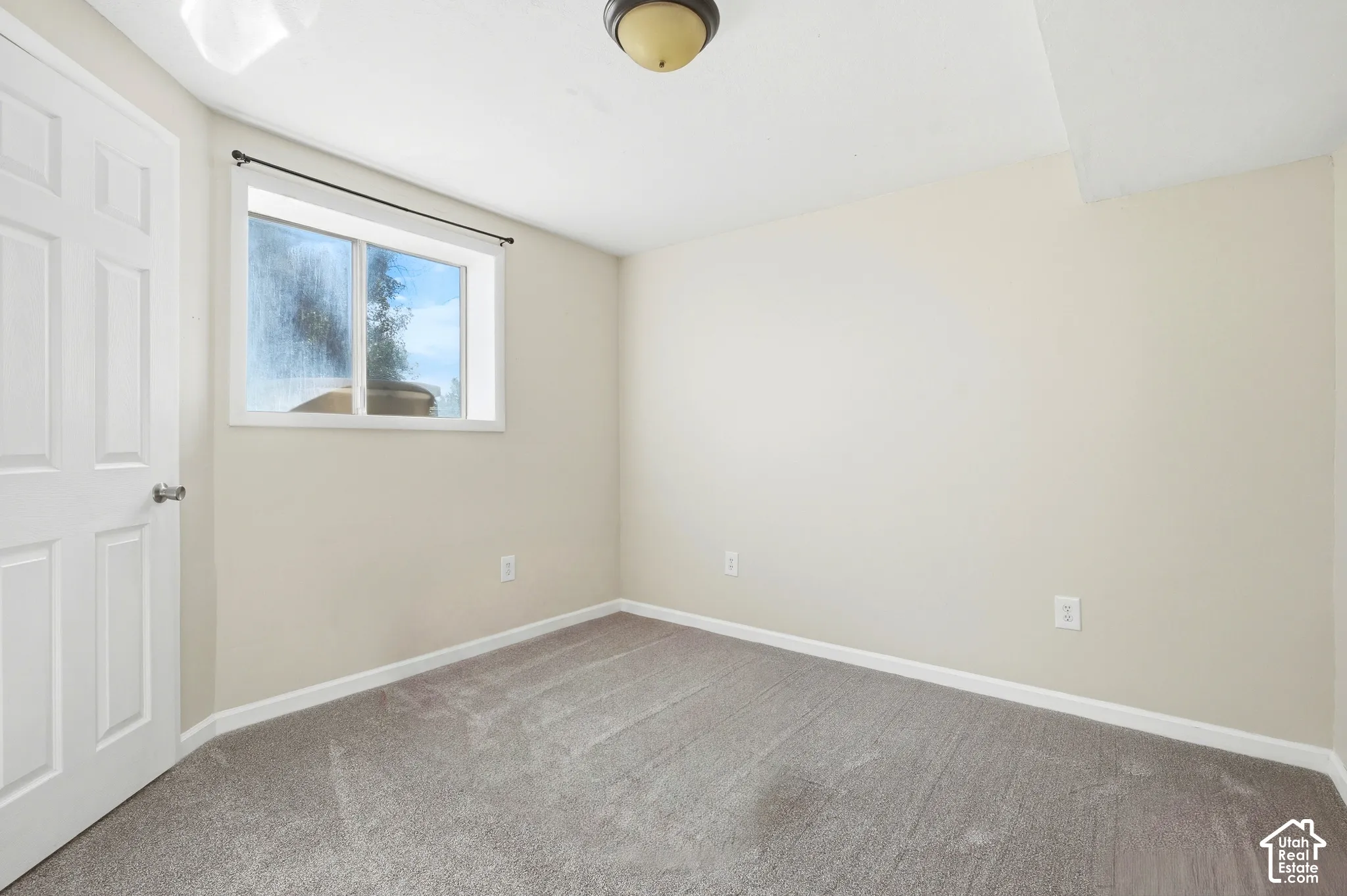 Neutral-toned walls complement the gray carpeting