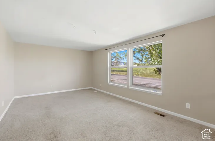 Neutral-toned walls complement the light-colored carpeting