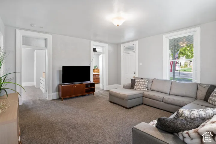 Light gray wall paint, white trim, and a white paneled door with an arched transom