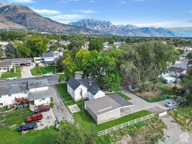 Property with mountain backdrop, surrounded by mature trees