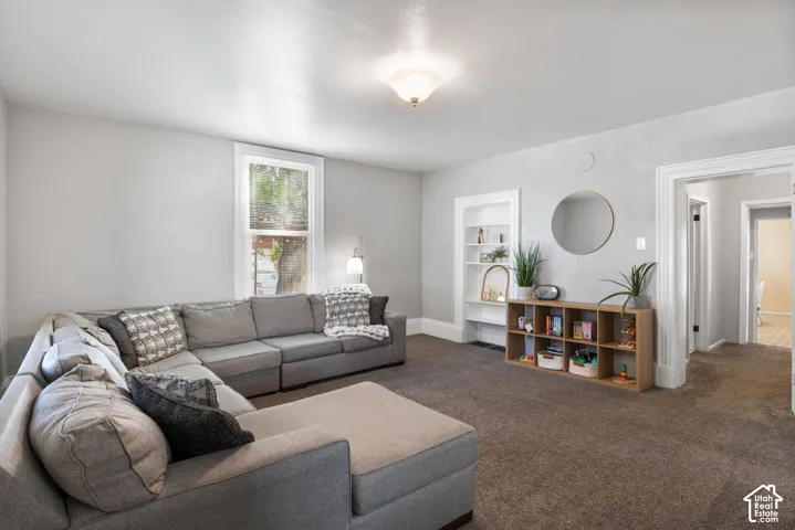 Neutral wall paint, recessed built-in shelving, overhead semi-flush mount lighting, and wall-to-wall carpeting
