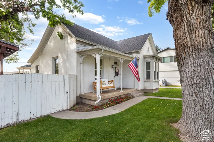Classic architectural style with a covered front porch, decorative porch columns, and a bay window
