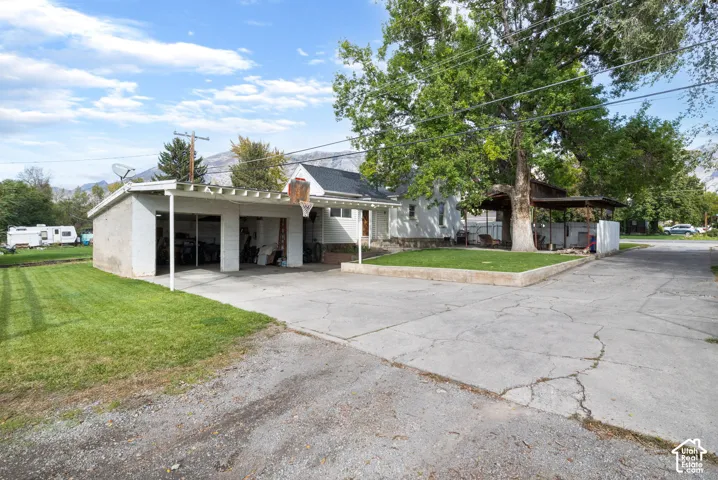 Paved driveway with an attached carport and a detached garage structure