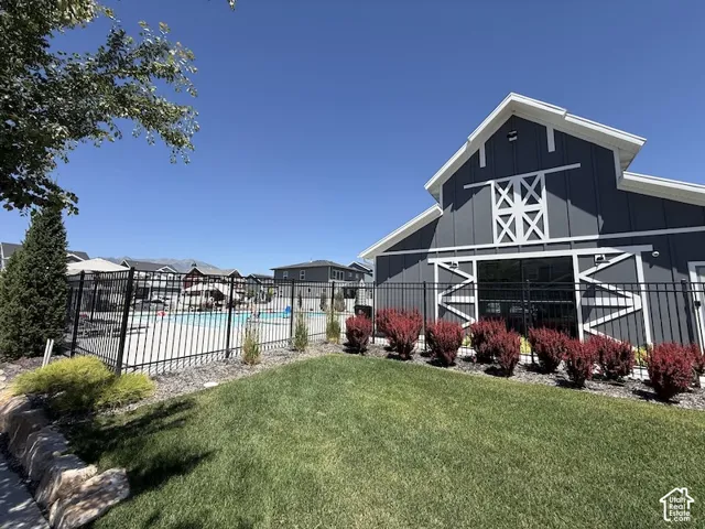 Exterior building with board and batten siding, barn-style architectural details, and white trim