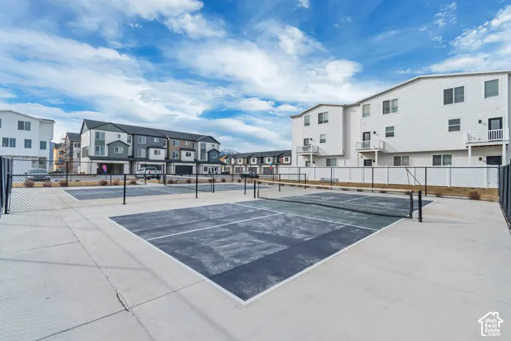 Community recreational courts with concrete surfacing and black chain-link fencing