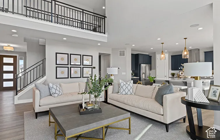HOME TO BE BUILT! Pictures are of another similar Spec and not of this exact home. Colors and other options may vary from those seen here. Please see Sales consultant for details. Open-concept living space featuring wood-finish flooring, recessed lighting