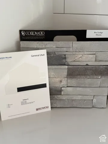 Exterior Colors. White with light gray stone, black facia and soffits, as well as black door and shutters.