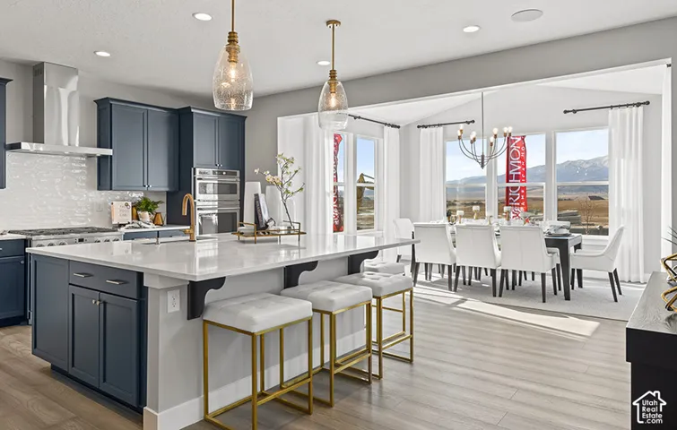 HOME TO BE BUILT! Pictures are of another similar Spec and not of this exact home. Colors and other options may vary from those seen here. Please see Sales consultant for details. Kitchen featuring dark cabinetry, white subway tile backsplash, and a larg
