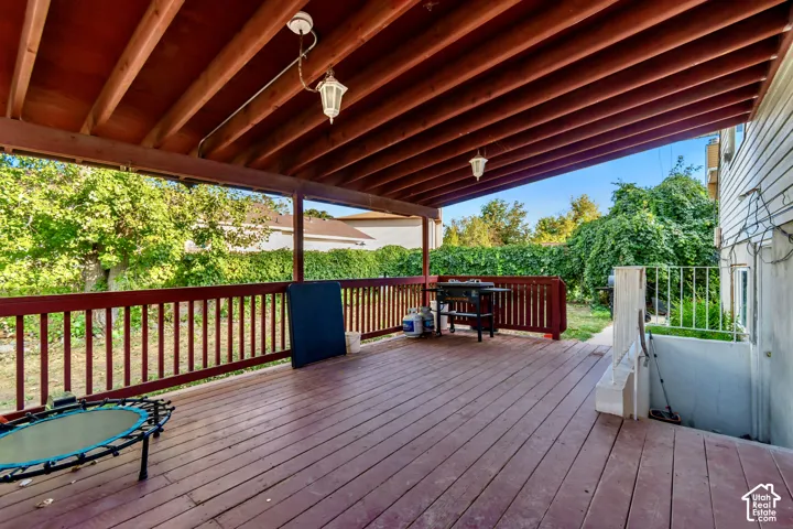 Expansive covered deck with wood-finish decking and exposed beam ceiling