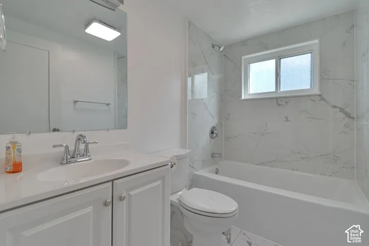 White bathroom vanity with built-in sink and chrome faucet
