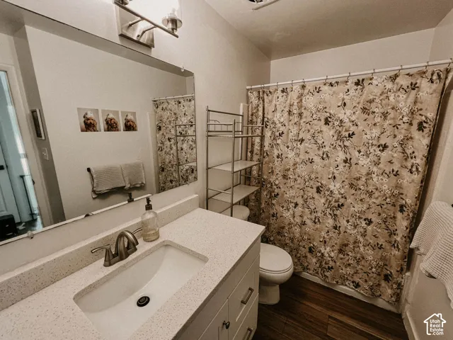White vanity with an integrated sink, brushed nickel faucet, and composite countertop