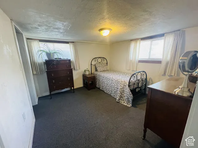 Carpeted flooring, recessed window, and white walls
