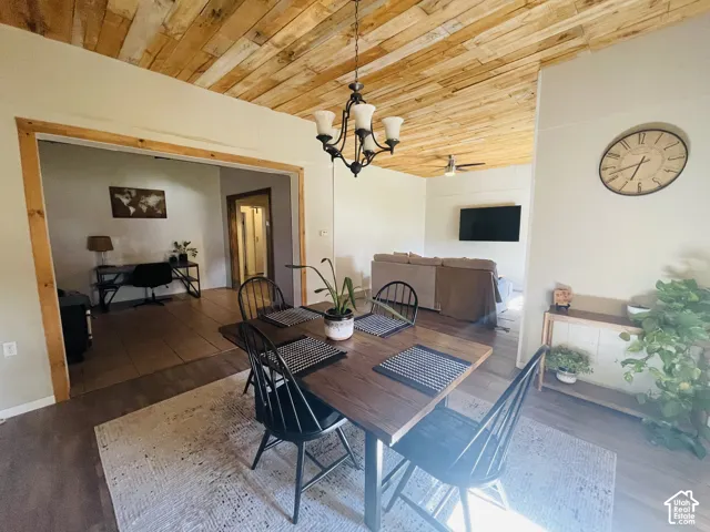 Vaulted wood-plank ceiling with a central chandelier