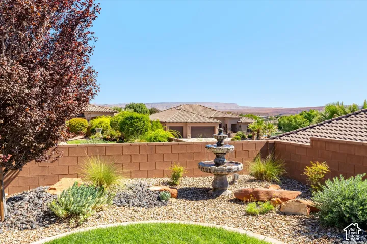 Tiered garden fountain with surrounding gravel and rock landscaping