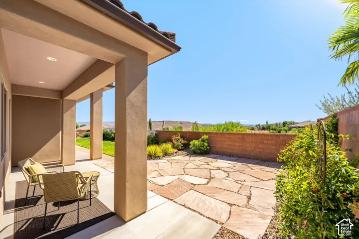 Covered patio with recessed lighting, concrete flooring, and a flagstone patio