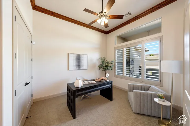 Sophisticated home office featuring a black desk, neutral palette with soft beige walls, and decorative ceiling beams