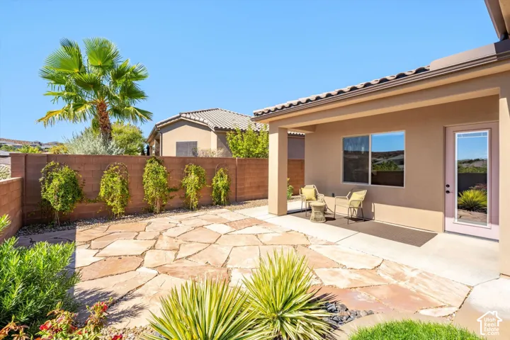 Covered patio with a tile roof, a full-lite door, and an exterior window