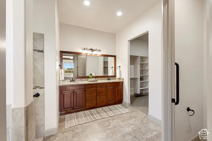 Dual vanity with granite countertop and dark wood cabinetry
