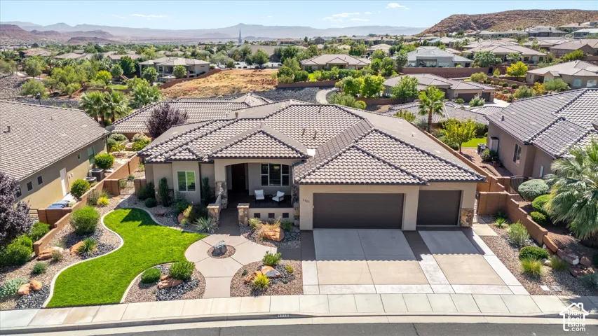 Stucco exterior with stone accents, tile roof, and a covered entry