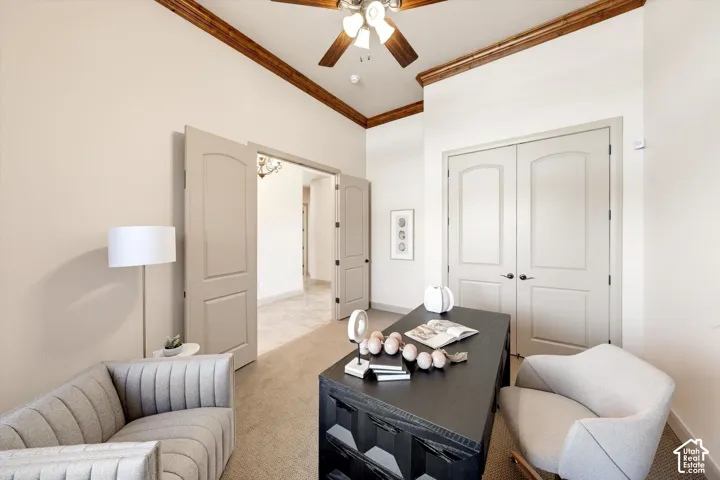 Vaulted ceiling with wood beam accents, ceiling fan, and double doors with arched transoms