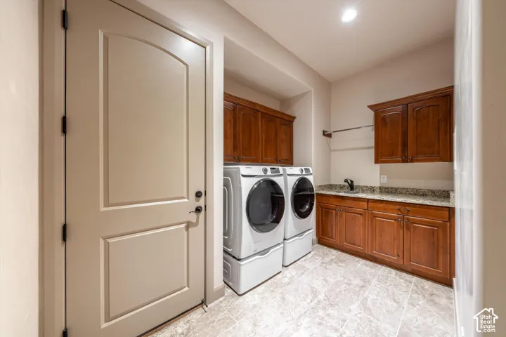 Tile flooring, wood cabinetry, granite-style countertop, integrated sink, and recessed lighting