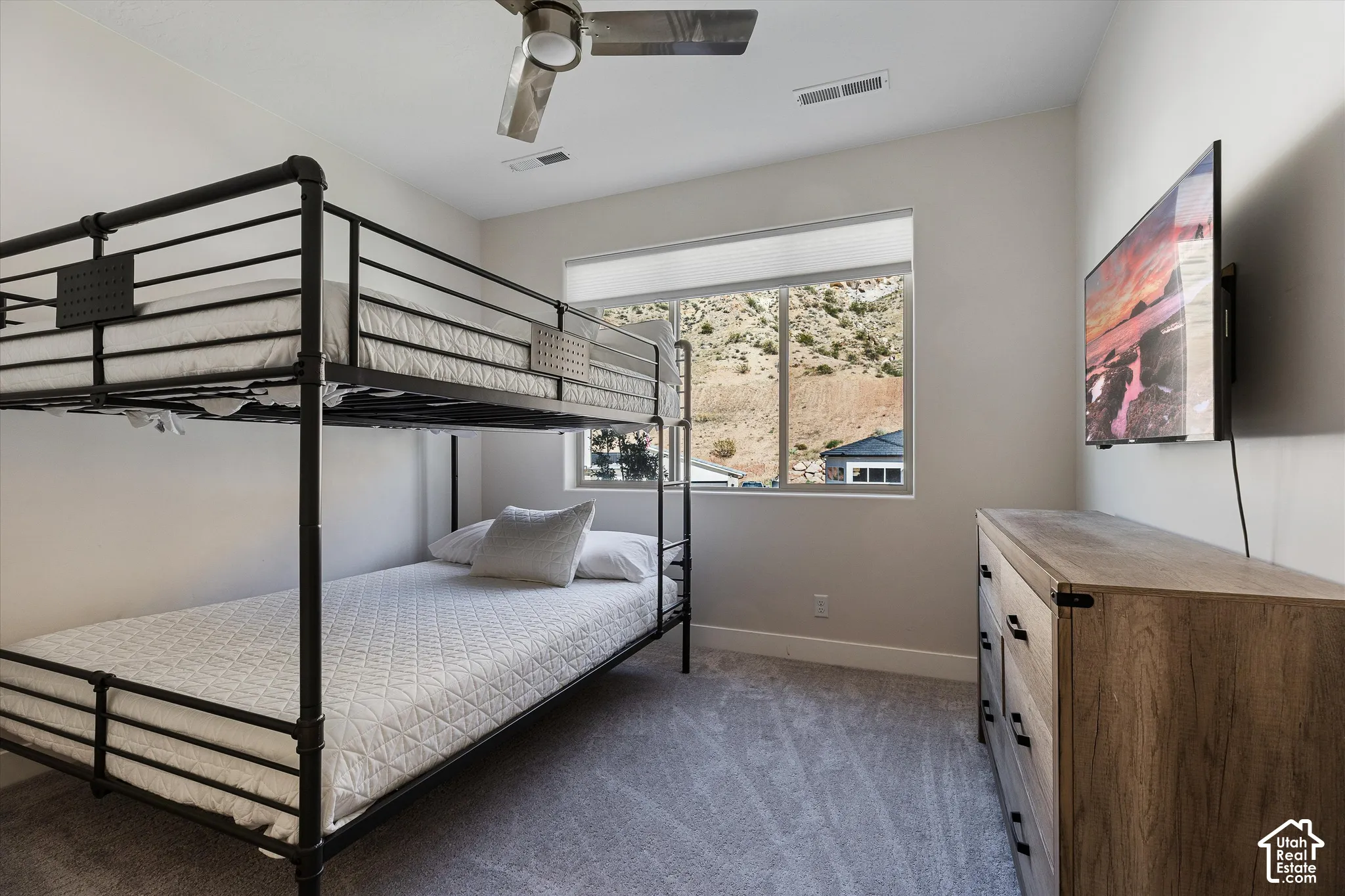 Recessed lighting, ceiling fan, window with roller shade, neutral wall paint, and gray carpet