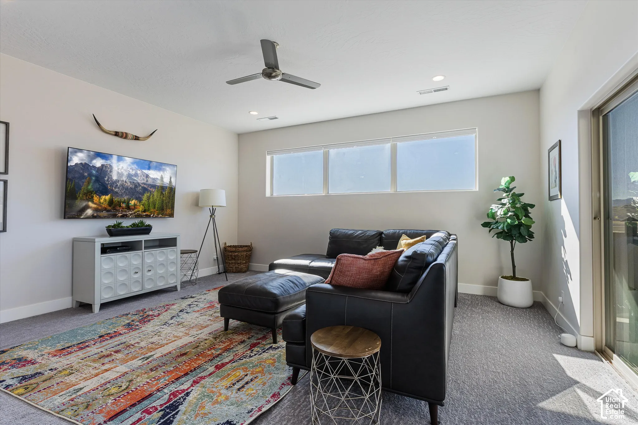 Recessed lighting, ceiling fan, and multiple windows provide ample illumination