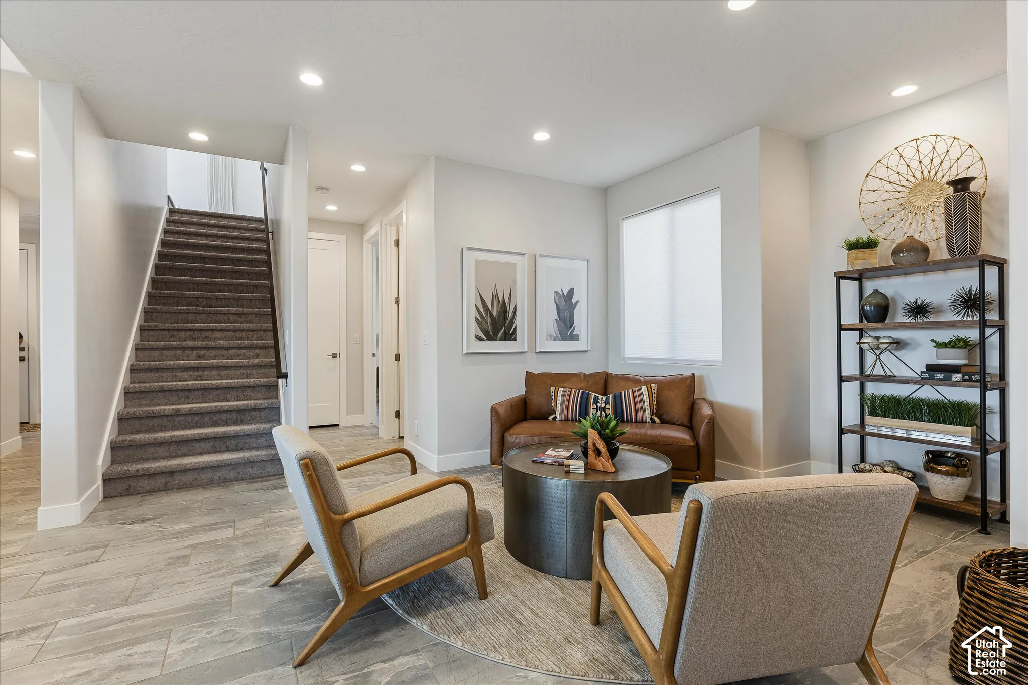 Recessed lighting, light gray wall tones, tiled flooring, built-in shelving, and a carpeted staircase with a dark handrail