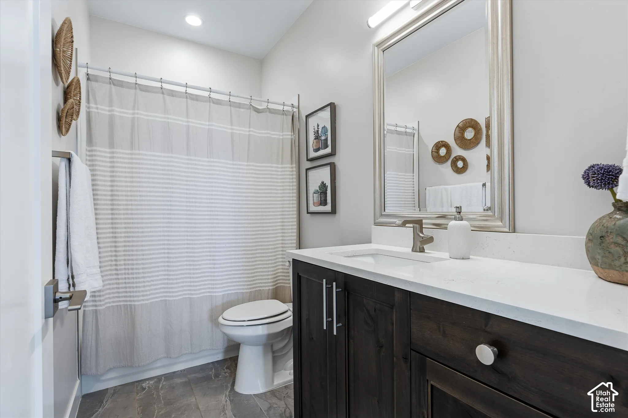 Dark wood-finish vanity with a white countertop and rectangular undermount sink