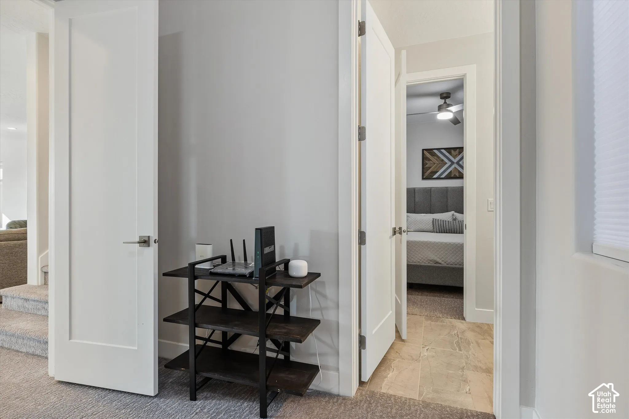 Hardwood flooring in bedroom, contemporary ceiling fan, and modern flat-panel interior doors