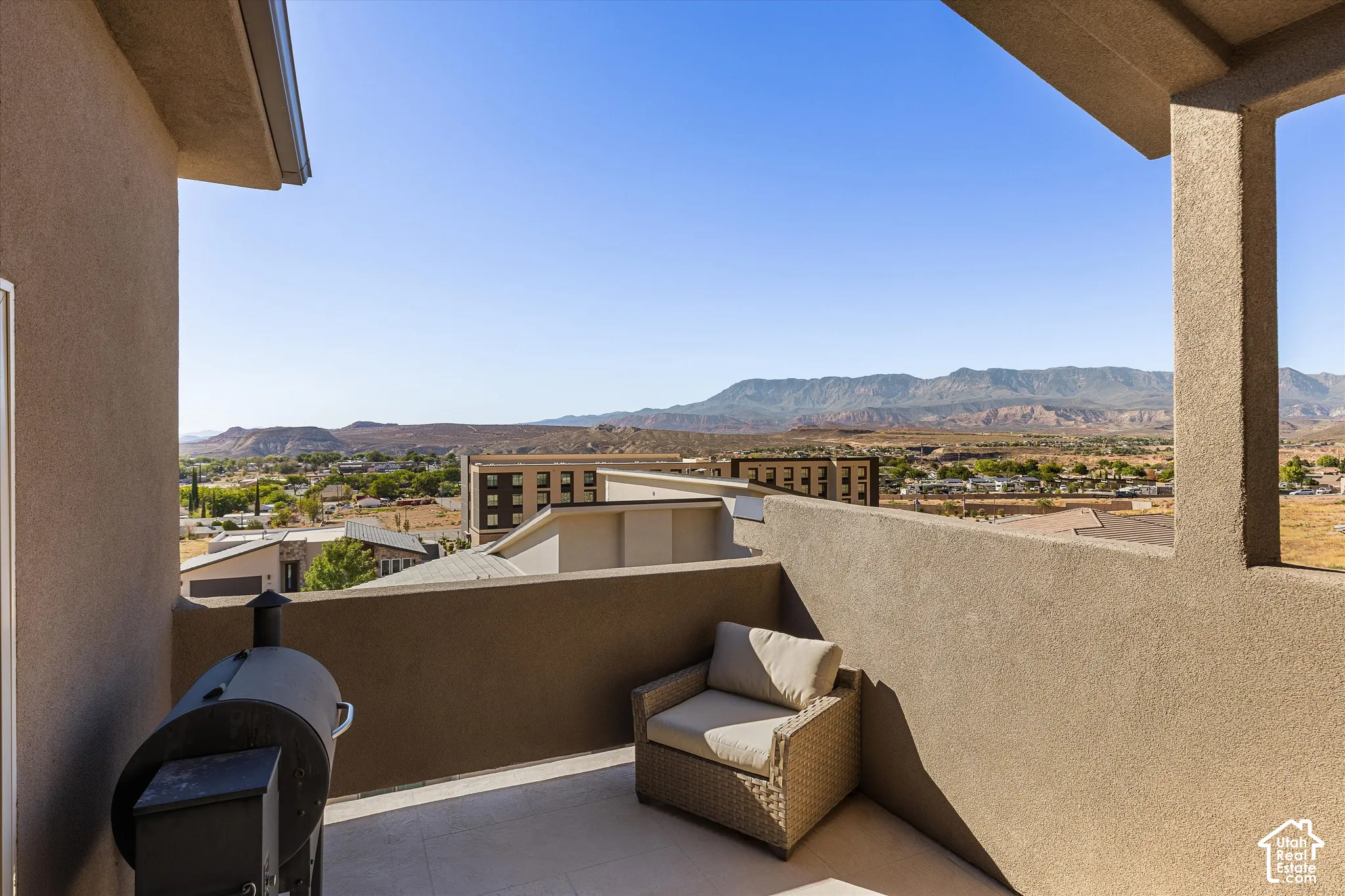 Terrace featuring a textured wall, tile flooring, and a panoramic mountain backdrop