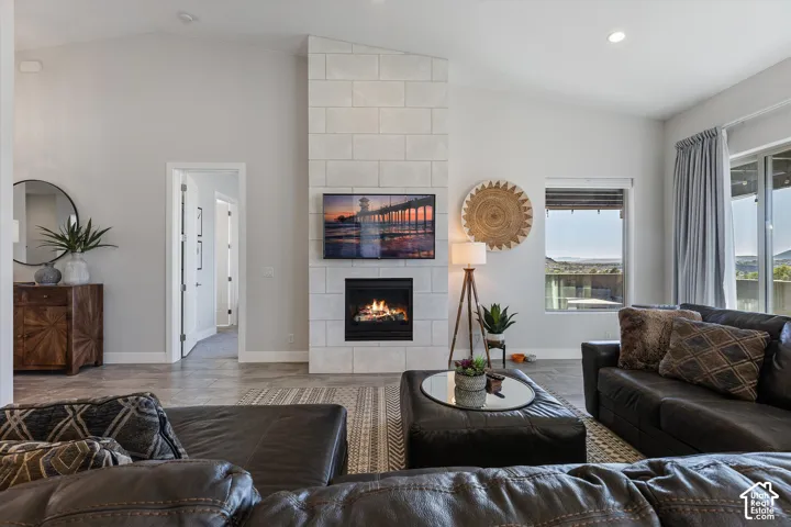 Living area featuring a floor-to-ceiling stone-faced fireplace with an integrated firebox