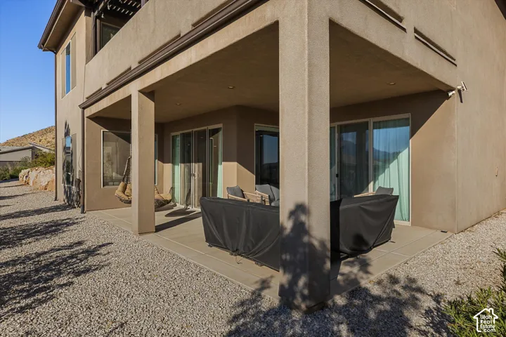 Covered patio with recessed lighting, stucco exterior, and sliding glass doors