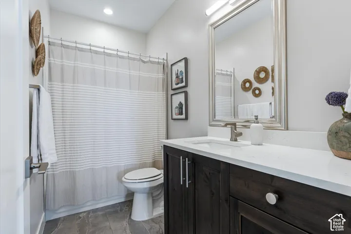 Dark wood-finish vanity with a white countertop and rectangular undermount sink