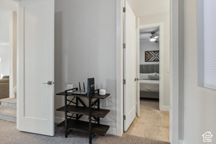 Hardwood flooring in bedroom, contemporary ceiling fan, and modern flat-panel interior doors