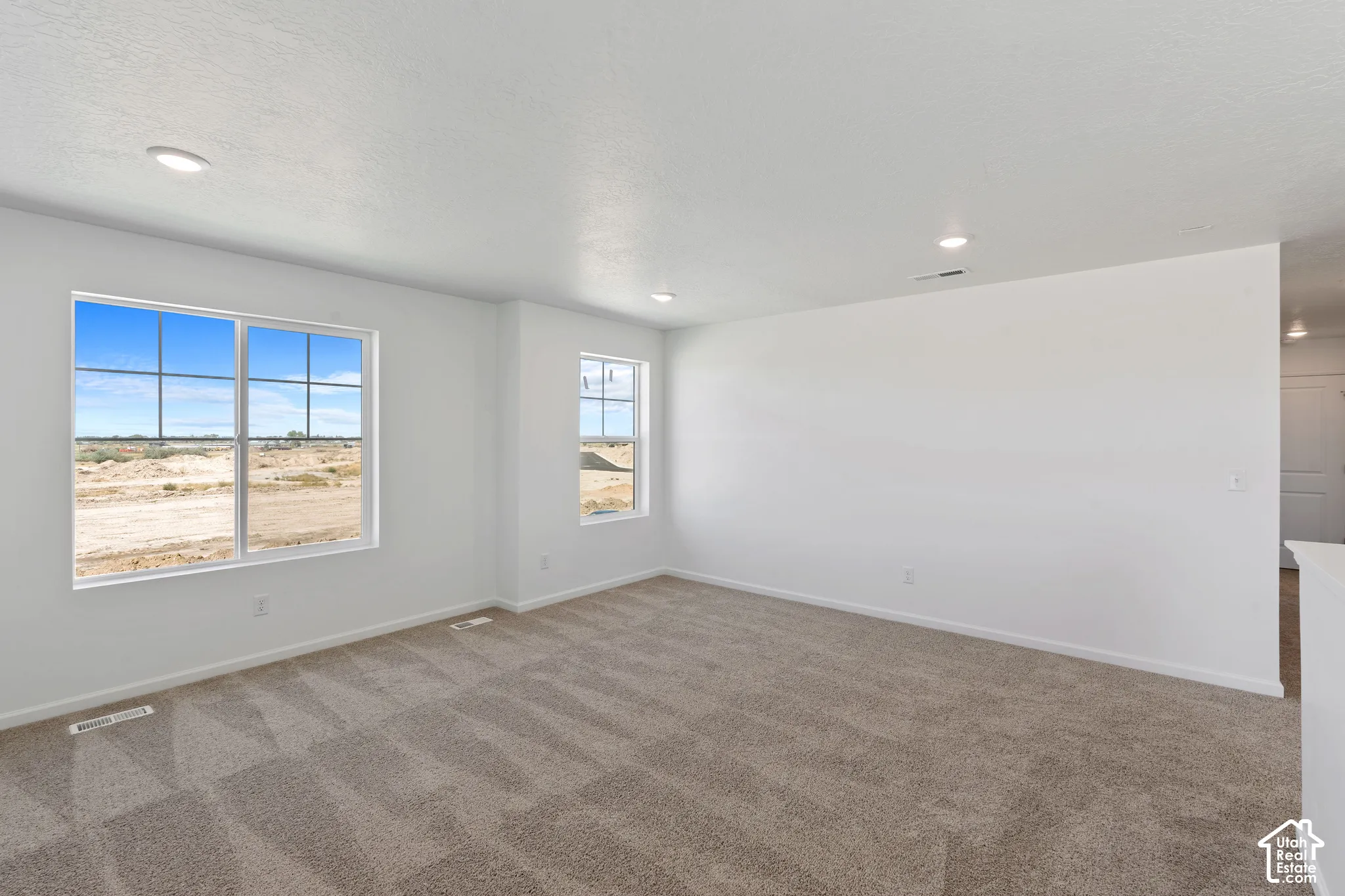 Picture from another model and for example only. Spacious interior featuring neutral paint, recessed lighting, and carpeted flooring