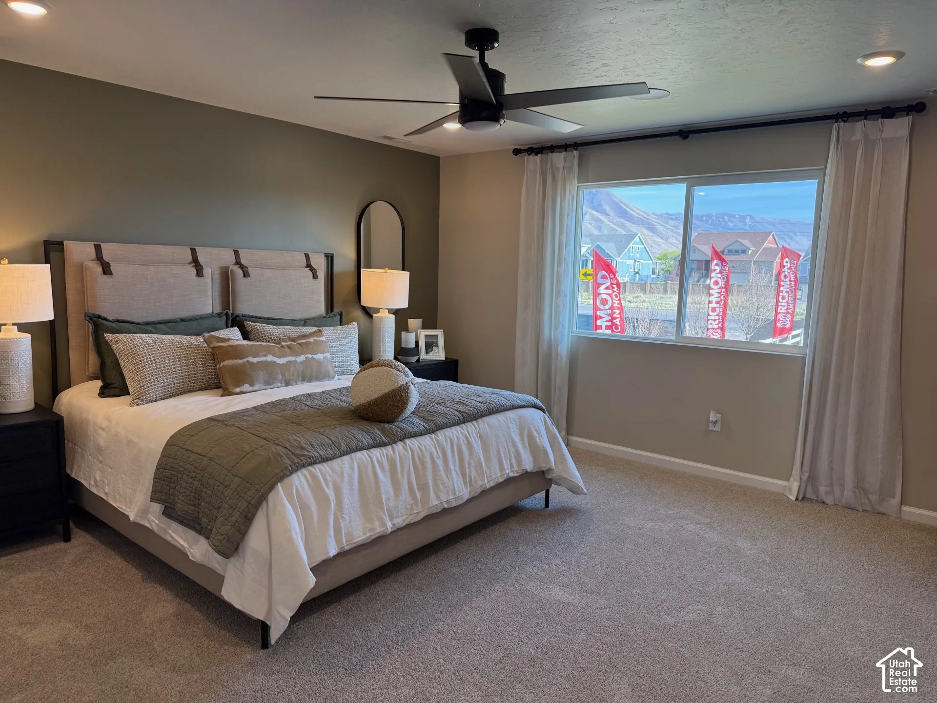 Picture from another model and for example only. Wall-to-wall carpeting, window with mountain backdrop, recessed lighting, ceiling fan, and upholstered headboard