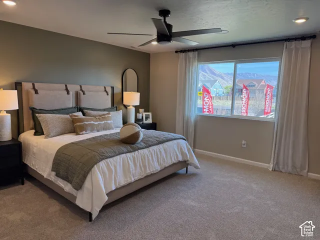 Picture from another model and for example only. Wall-to-wall carpeting, window with mountain backdrop, recessed lighting, ceiling fan, and upholstered headboard