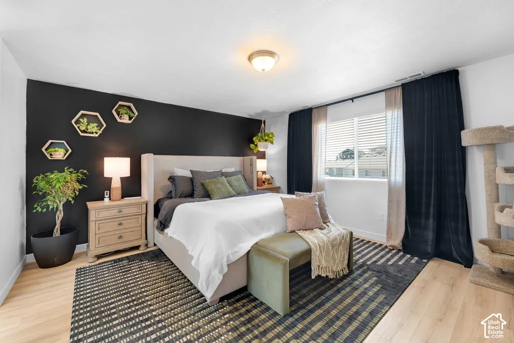 Light wood-finish flooring with a dark accent wall