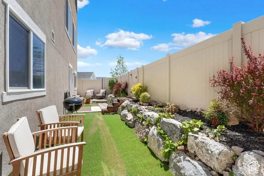 Manicured lawn area with rock landscaping and mature plantings