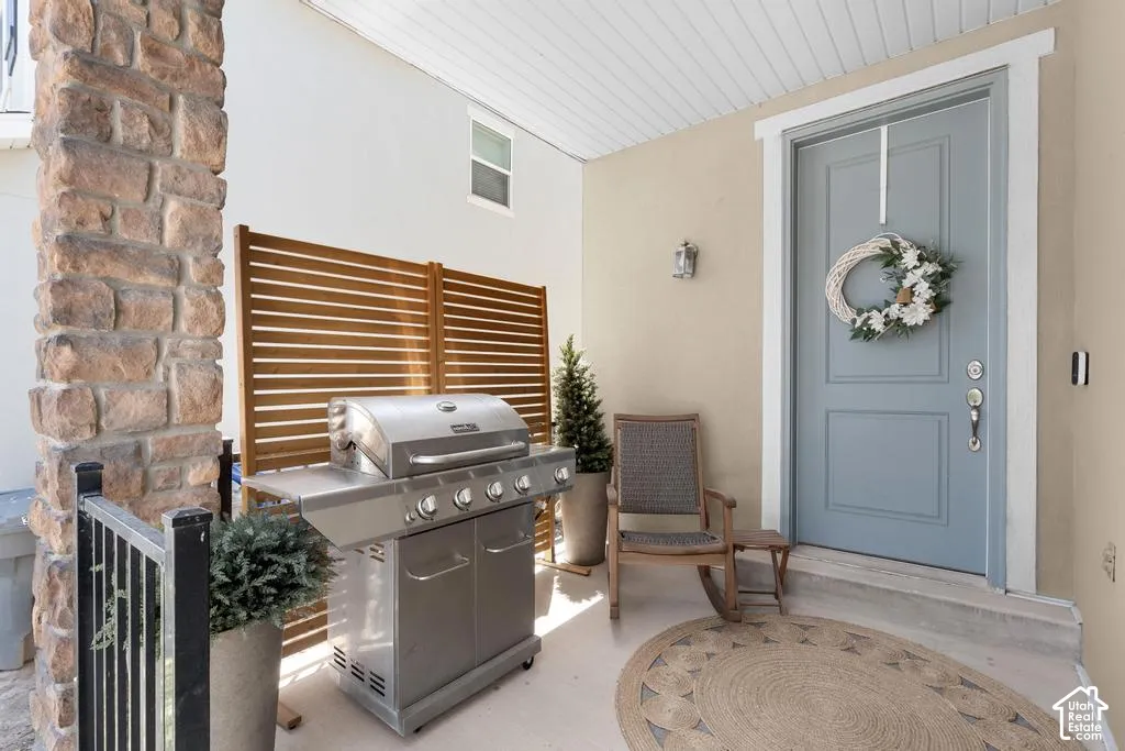Stone pillar accenting a covered porch with a light blue entry door
