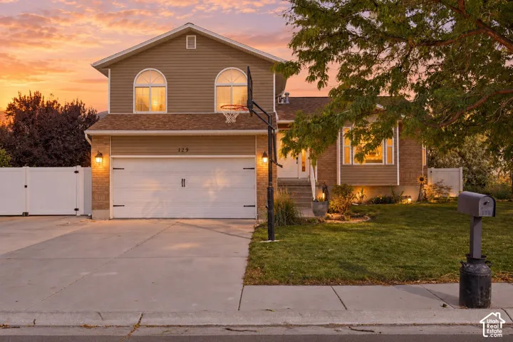 Two-story residence featuring arched windows and a prominent garage