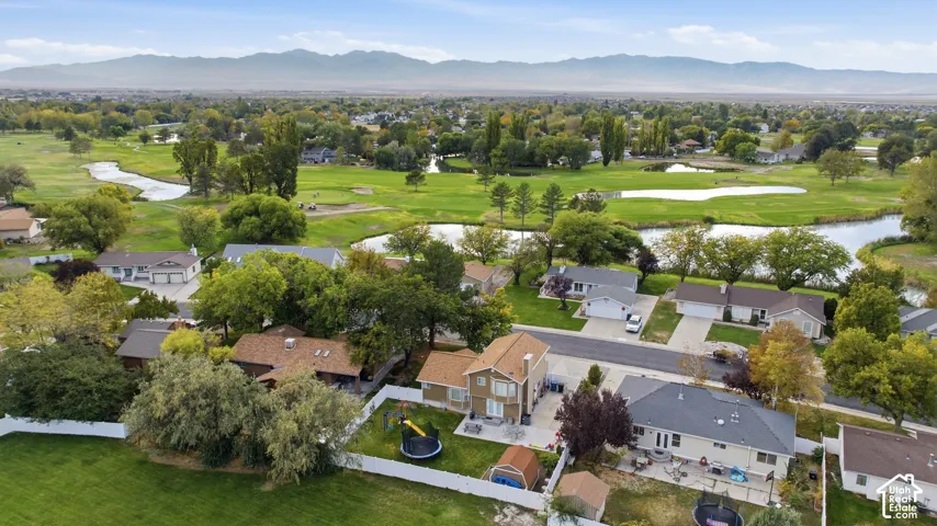 Aerial view showcasing a substantial residential property with manicured landscaping, mature trees, and multiple outbuildings on expansive grounds